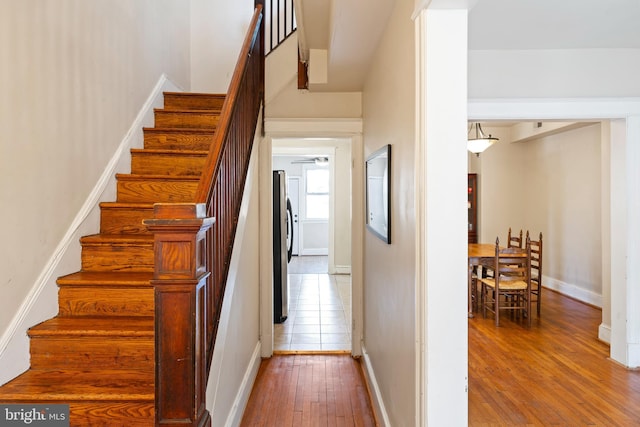 staircase with baseboards and hardwood / wood-style floors