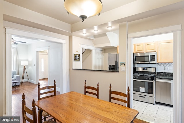 dining area with light tile patterned floors and baseboards