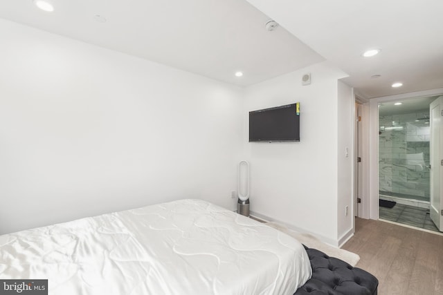 bedroom featuring baseboards, wood finished floors, and recessed lighting