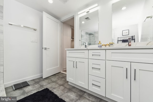 full bathroom with double vanity, a shower stall, visible vents, and recessed lighting