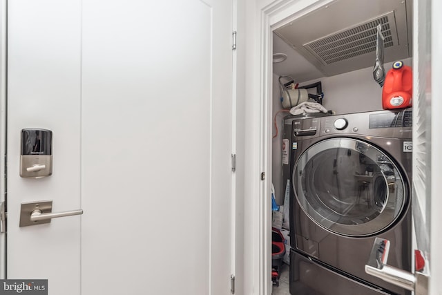 laundry area with washer / clothes dryer, visible vents, and laundry area