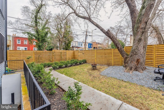 view of yard featuring an outdoor fire pit and a fenced backyard