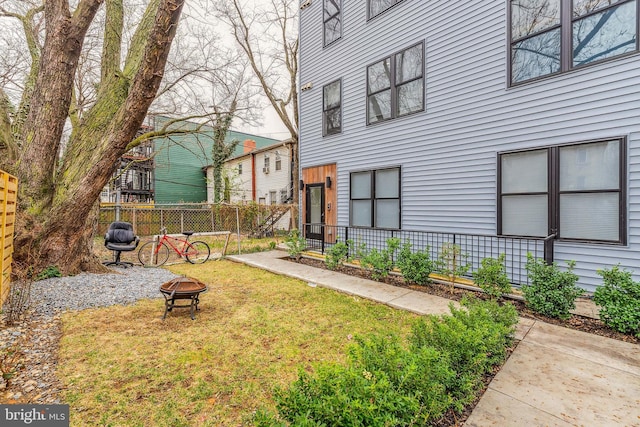 view of yard featuring a fire pit and fence