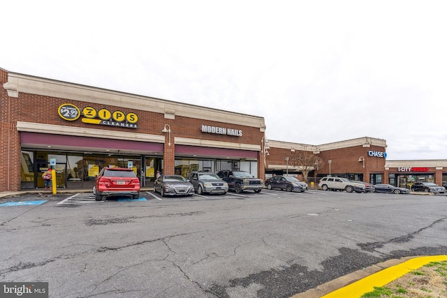 view of building exterior with uncovered parking