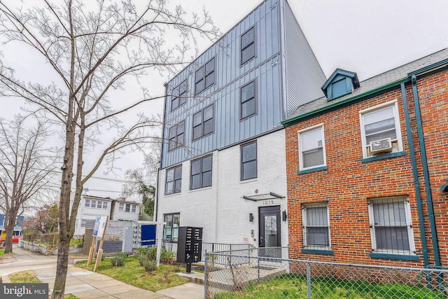 exterior space with a fenced front yard and cooling unit