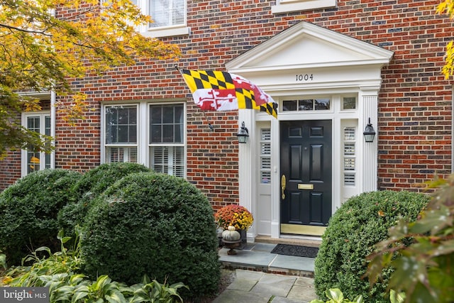 property entrance with brick siding