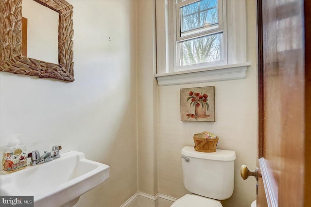 half bathroom with a sink and toilet