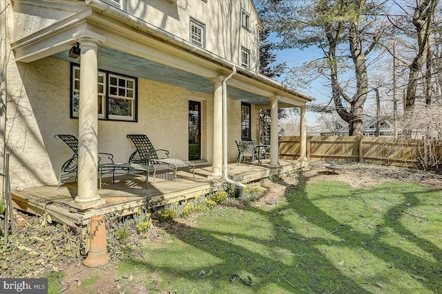 exterior space with fence and stucco siding