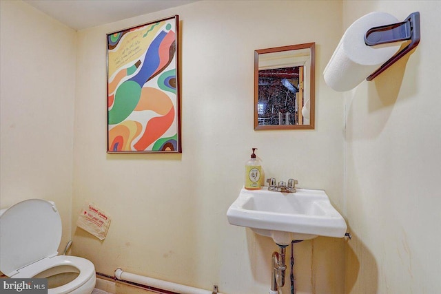 bathroom featuring toilet and a sink