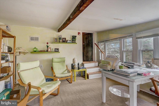 sitting room featuring carpet, visible vents, and beamed ceiling