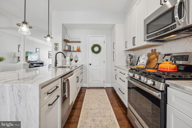 kitchen featuring appliances with stainless steel finishes, a sink, dark wood finished floors, and light stone countertops