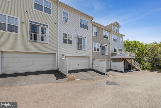 rear view of property featuring a wooden deck and stairs