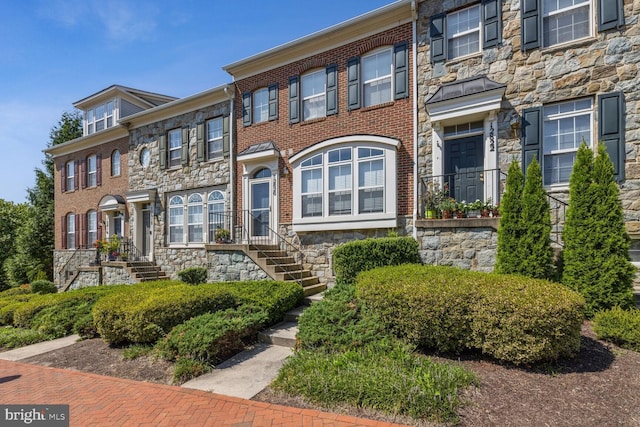 townhome / multi-family property featuring brick siding