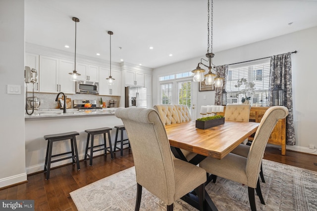 dining room with baseboards, dark wood-style flooring, and recessed lighting