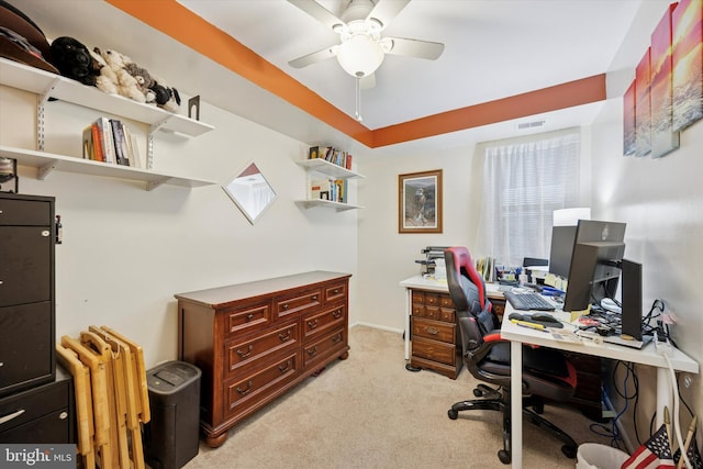 home office featuring light colored carpet, ceiling fan, visible vents, and radiator heating unit