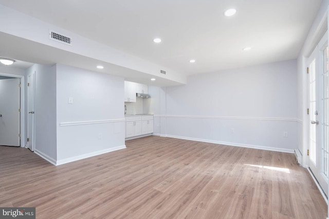 unfurnished living room with light wood-style flooring, recessed lighting, and visible vents