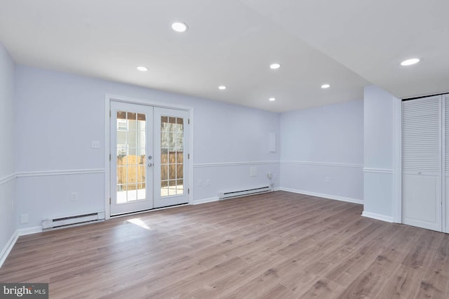 empty room with recessed lighting, french doors, baseboard heating, and wood finished floors