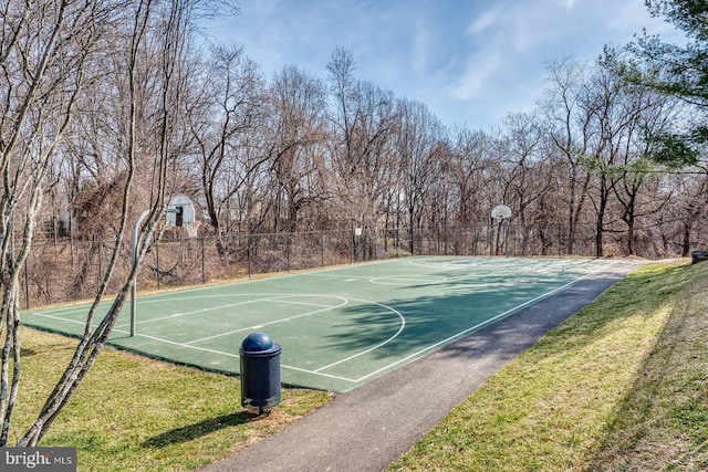 view of basketball court featuring community basketball court, a yard, and fence