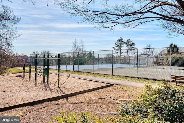 view of home's community with playground community, a tennis court, and fence