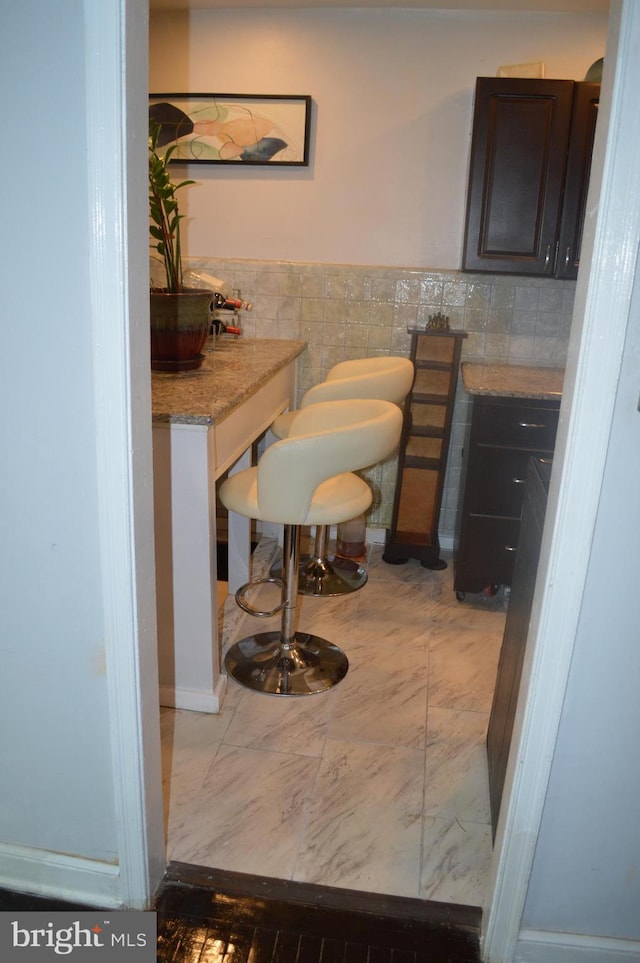 bathroom with toilet, tile walls, and wainscoting