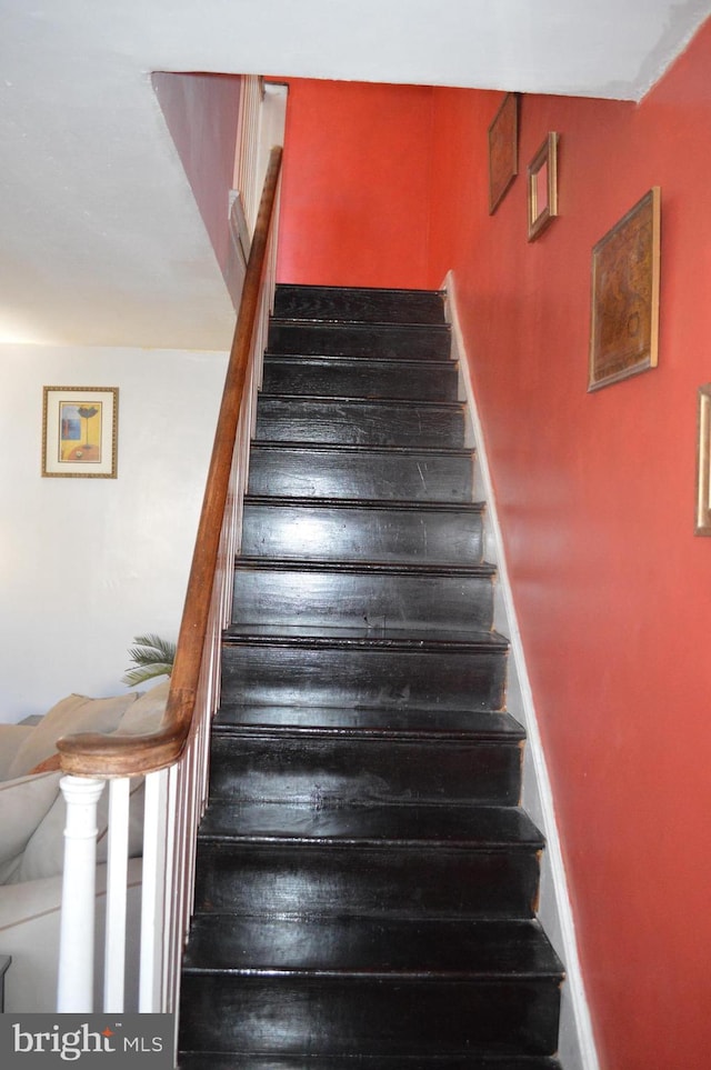 staircase featuring baseboards