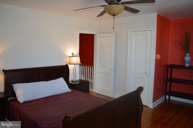 bedroom featuring baseboards and wood finished floors