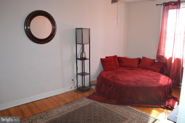 bedroom featuring baseboards and wood finished floors