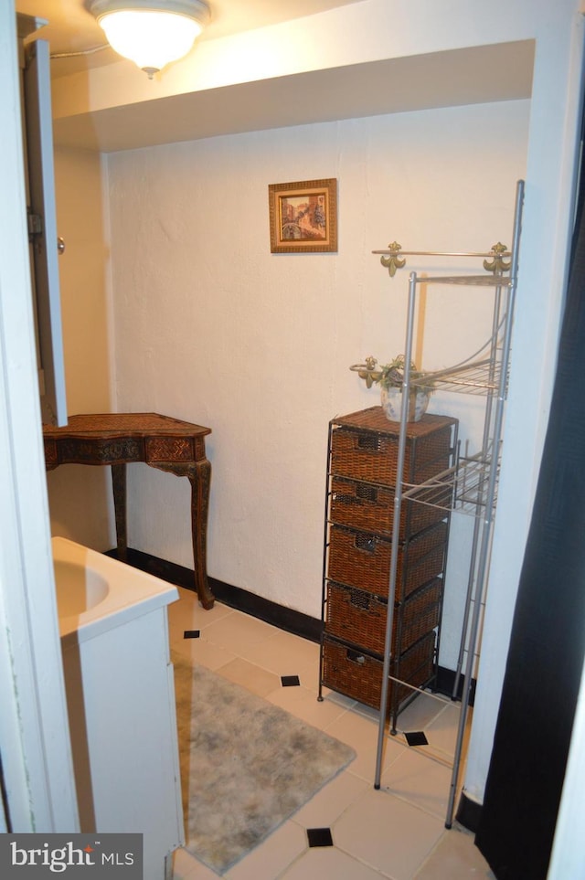 hall with tile patterned flooring and baseboards