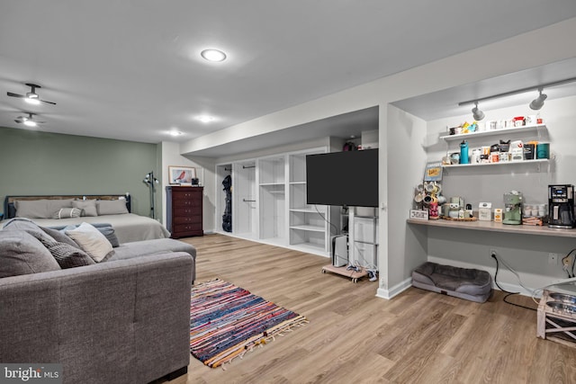 bedroom with wood finished floors and baseboards