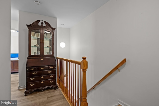 staircase with wood finished floors