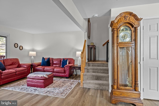 living room with stairway and wood finished floors