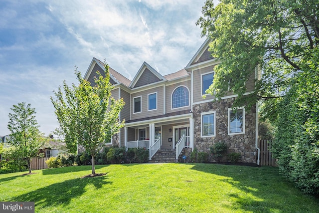856 N Harrison St, Arlington, VA 22205 - craftsman-style home featuring a porch, fence, stone siding, and a front lawn