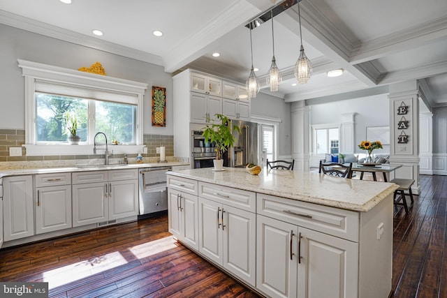 856 N Harrison St, Arlington, VA 22205 - kitchen featuring ornamental molding, dark wood-style flooring, a kitchen island, a sink, and appliances with stainless steel finishes