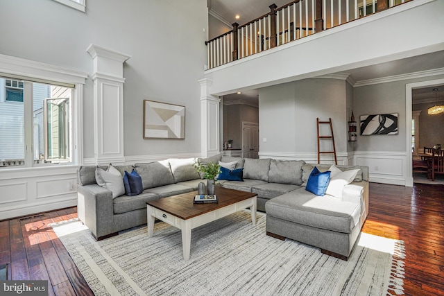 856 N Harrison St, Arlington, VA 22205 - living room with a high ceiling, a decorative wall, wood-type flooring, ornate columns, and ornamental molding