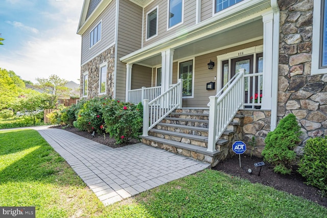 856 N Harrison St, Arlington, VA 22205 - doorway to property featuring a porch, a lawn, and stone siding