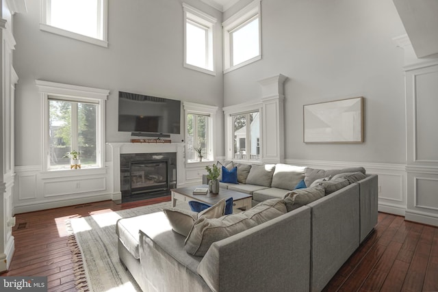 856 N Harrison St, Arlington, VA 22205 - living area with dark wood-style flooring, a glass covered fireplace, and a healthy amount of sunlight
