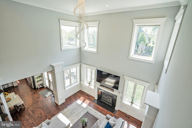 856 N Harrison St, Arlington, VA 22205 - living area featuring a healthy amount of sunlight, crown molding, a fireplace with flush hearth, and a towering ceiling