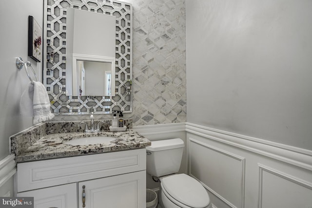 856 N Harrison St, Arlington, VA 22205 - bathroom with vanity, toilet, wainscoting, and a decorative wall
