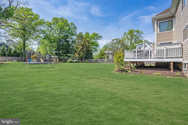856 N Harrison St, Arlington, VA 22205 - view of yard with a fenced backyard, a trampoline, and a deck