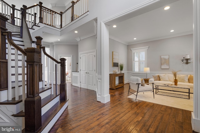 856 N Harrison St, Arlington, VA 22205 - entryway with crown molding, dark wood finished floors, stairs, and a wainscoted wall