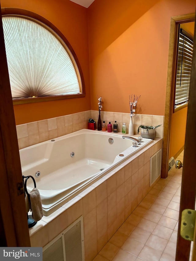 full bath with a whirlpool tub, tile patterned flooring, and visible vents