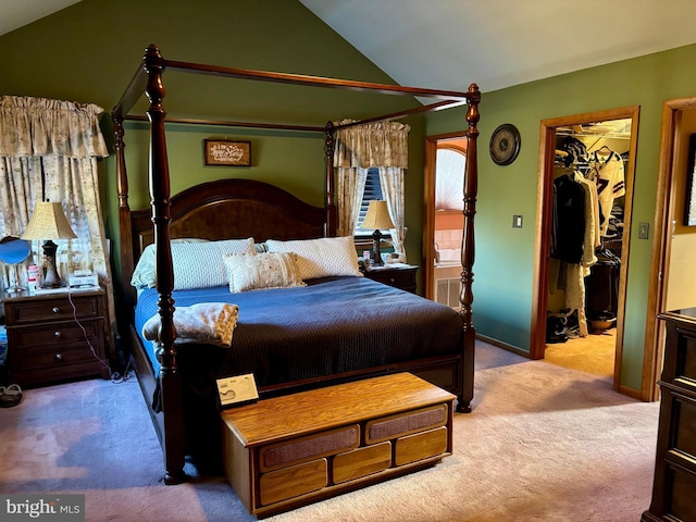 bedroom with lofted ceiling, carpet floors, a closet, and a walk in closet