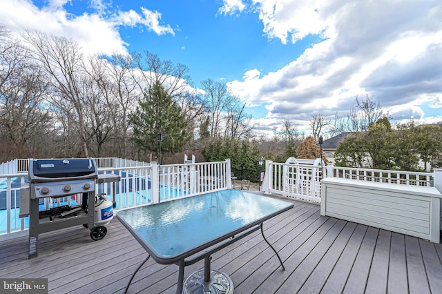 wooden deck with a grill and an outdoor pool