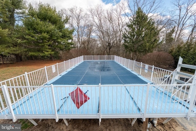 view of pool featuring fence