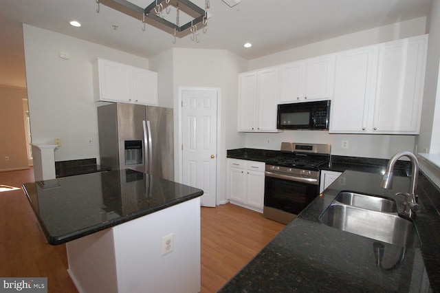 kitchen with stainless steel appliances, light wood-type flooring, white cabinetry, a sink, and recessed lighting