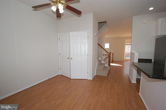 interior space featuring visible vents, baseboards, stairway, and light wood finished floors