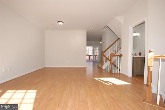 interior space with light wood-style floors, stairs, and baseboards