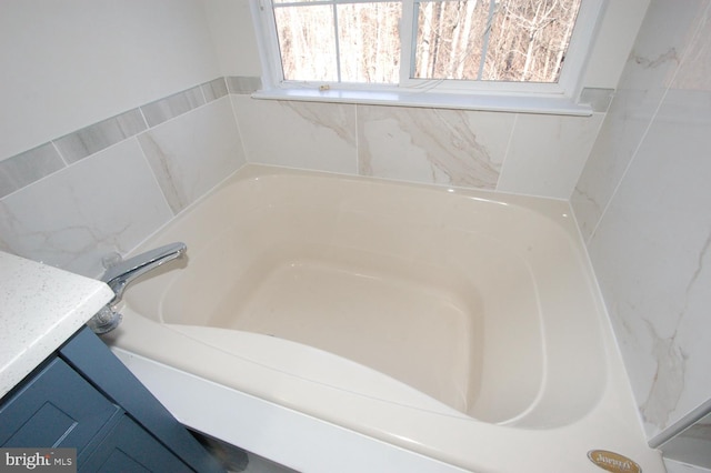 full bath with a bathtub and vanity