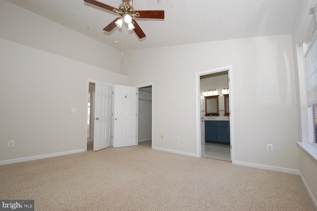 unfurnished bedroom featuring ensuite bathroom, a closet, carpet, and baseboards