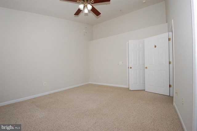 unfurnished room with a ceiling fan and baseboards